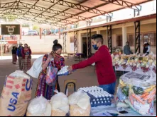 Distribuição de alimentos pela Catholic Relief Services para crianças em idade escolar em escola do departamento de Totonicapán, Guatemala, com a ajuda de pais voluntários.